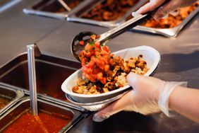 An employee prepares a burrito bowl at a Chipotle Mexican Grill restaurant 