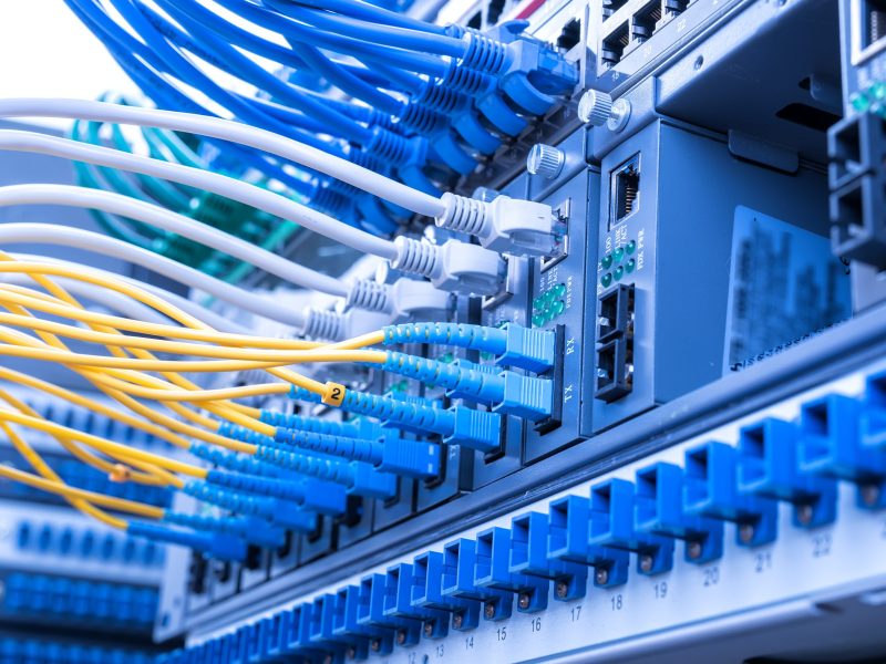 Fiber Optic cables connected to an optic ports and Network cables connected to ethernet ports.