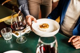 A waiter serving a customer 