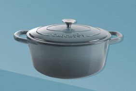 A CrockPot dutch overn on a two tone blue background.