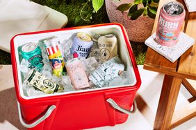 A cooler filled with ice and canned drinks