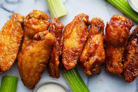 line of buffalo chicken wings drenched in different sauces