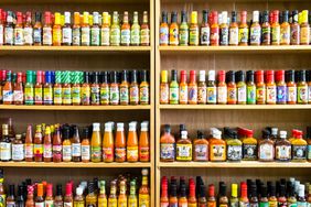 Various hot sauces on grocery store shelves