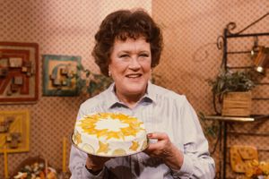 Julia Child holds up a dessert