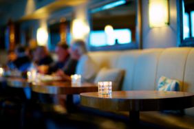 An empty booth at a crowded restaurant