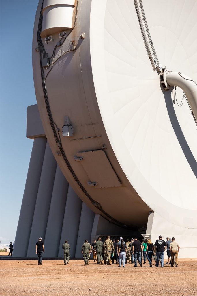 Photo of SpinLaunch employees walking toward one of the company’s “suborbital accelerators."