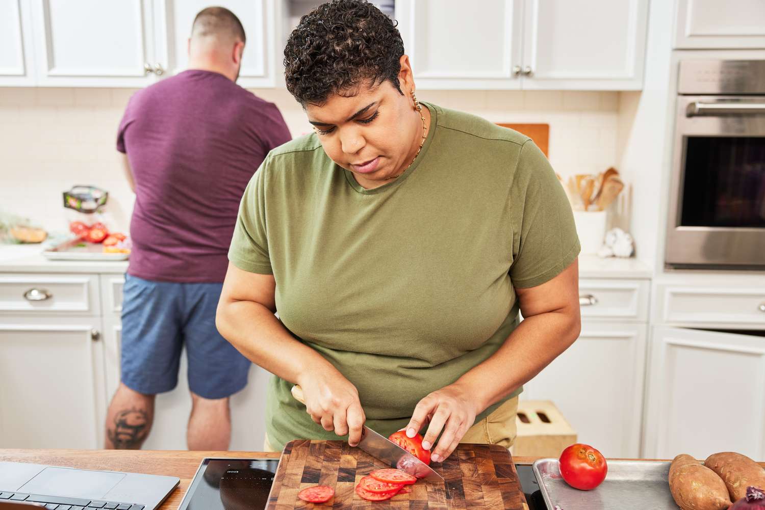 Woman Using Shun Classic Chef's Knife to Cut Tomato