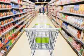 A grocery store aisle and empty cart