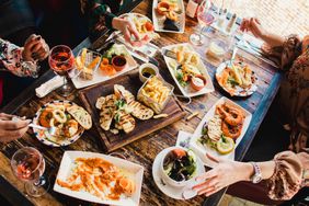 A group of friends sharing plates at a restaurant