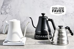 Three Gooseneck Kettles sitting on a marble table with a marble wall