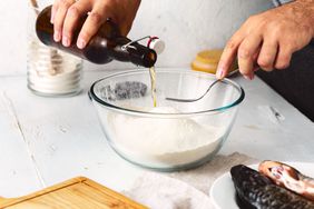 A person prepares a batter with leftover beer