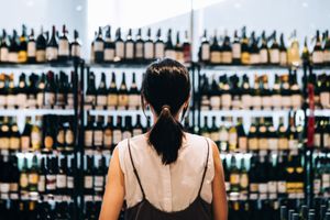 A person shops in a wine store